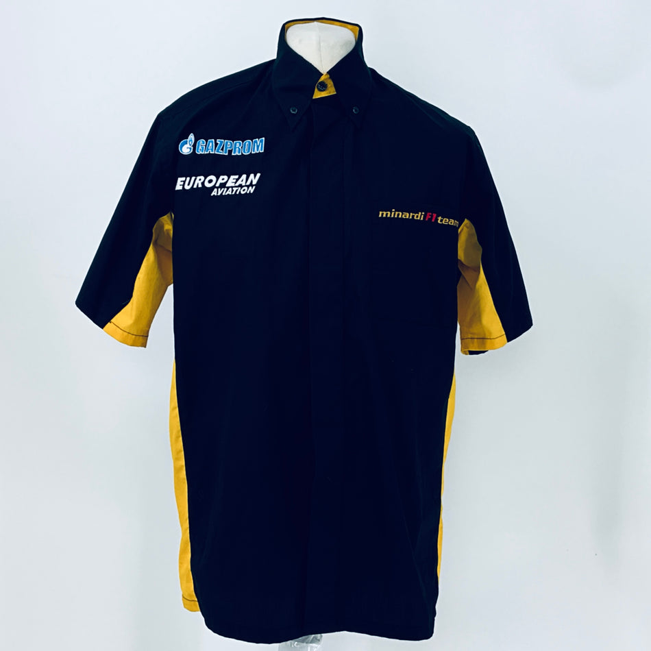 Front view navy pit crew shirt with yellow sleeve panels, button-up collar, and “GAZPROM” logo