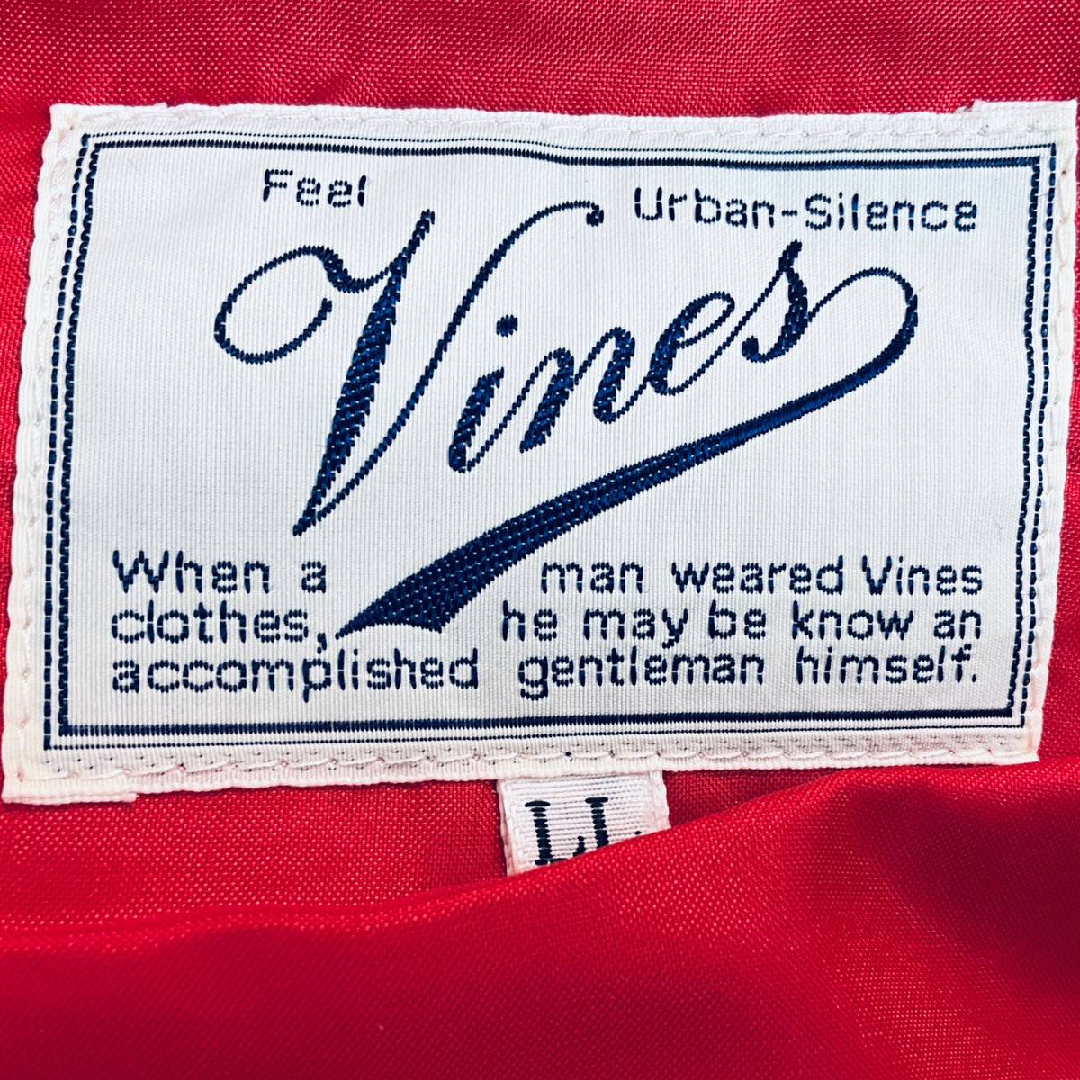 Red jacket lining with Vines label and blue decorative text patch