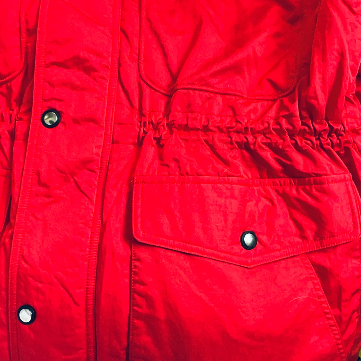 Red winter jacket with buttoned flap pockets and quilted midsection