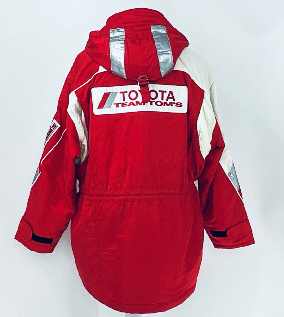 Red and off-white winter parka jacket with hood, back Team TOM'S logo, and rear patch details