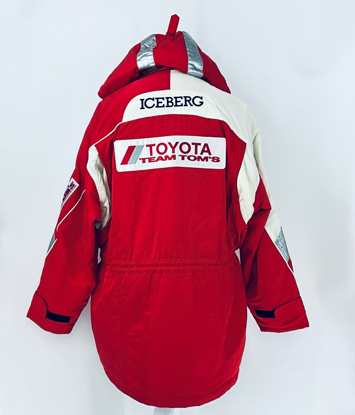 Red winter parka jacket with hood, ICEBERG back logo, and Team TOM'S branding patch