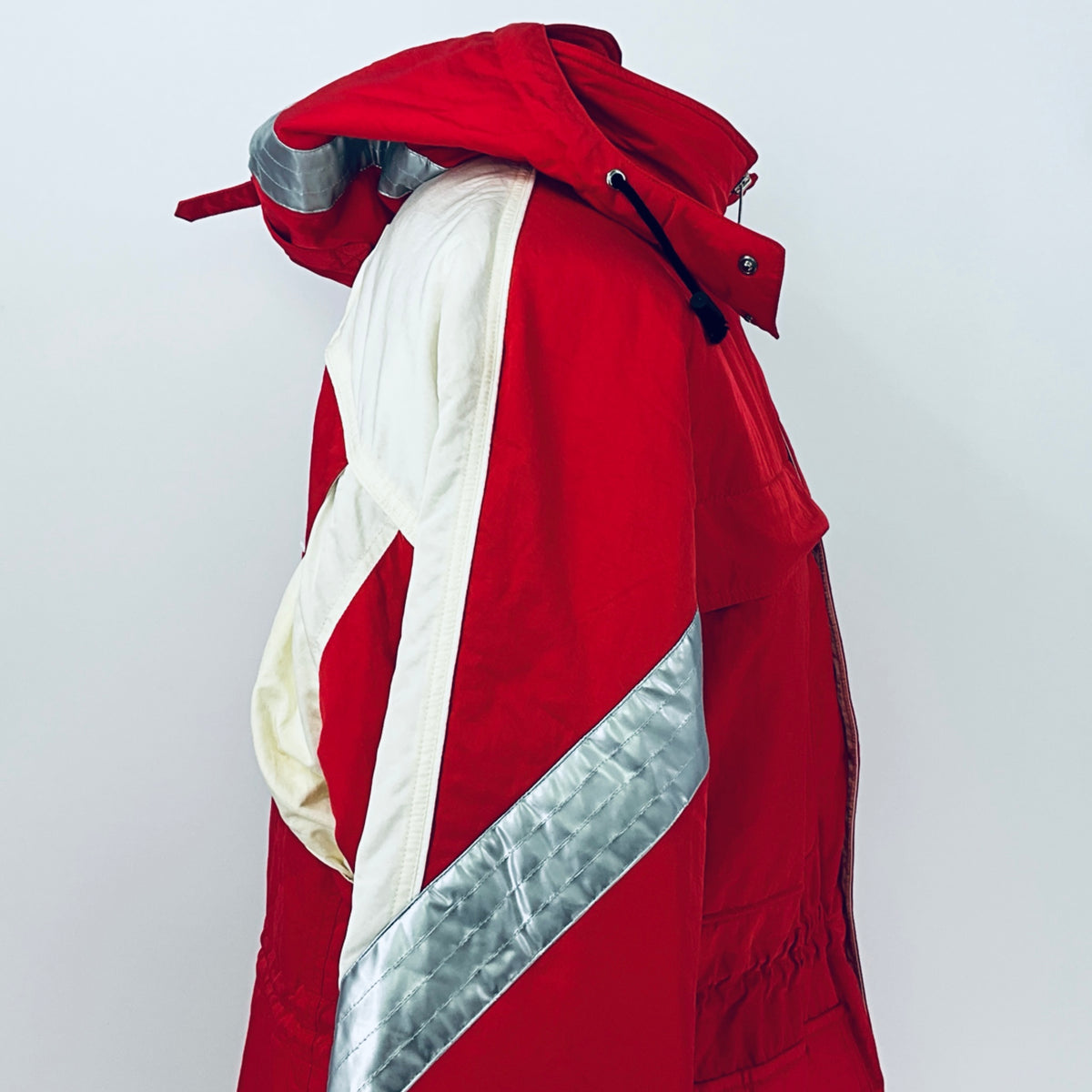 Red winter parka jacket with off-white hood lining and silver-gray diagonal side panel