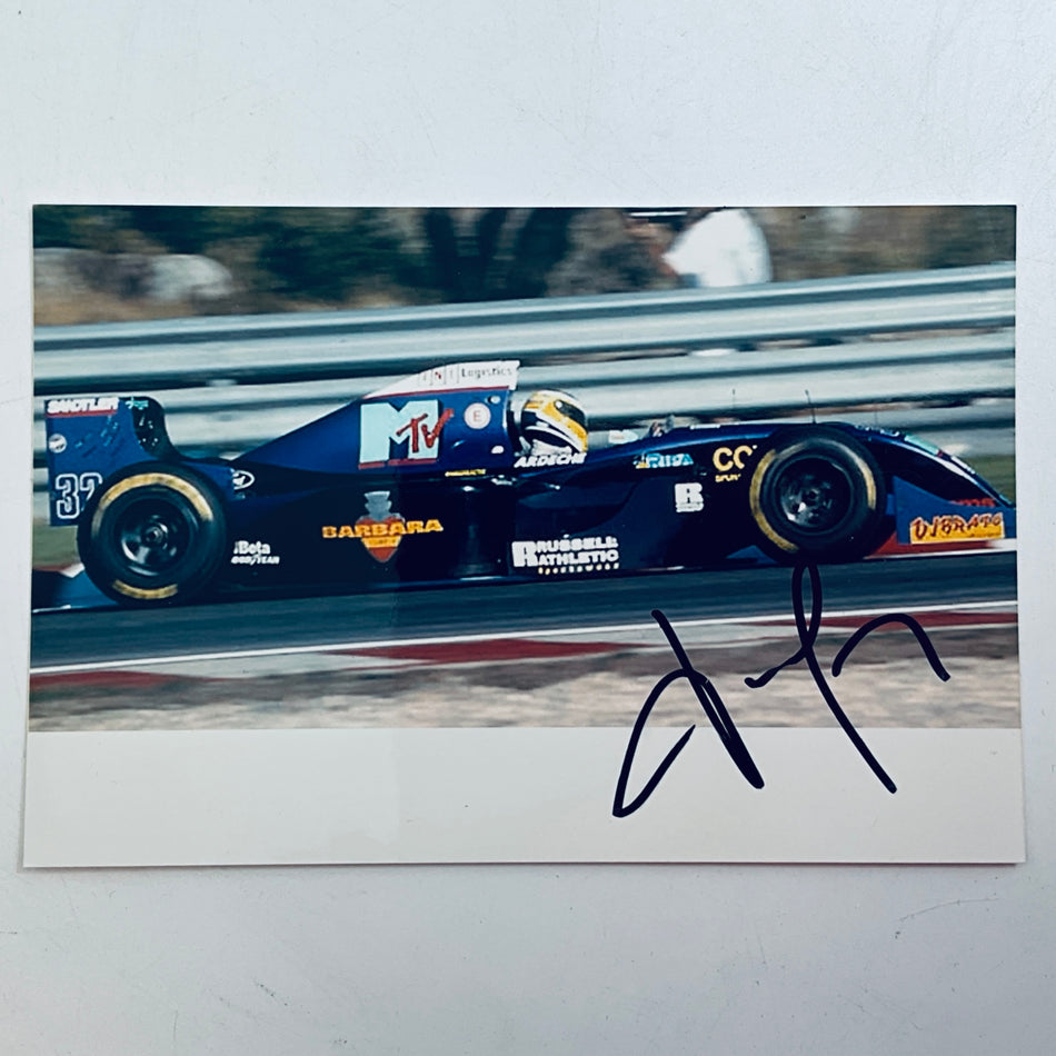 Signed racing car photo print with blue car and large black autograph on white border