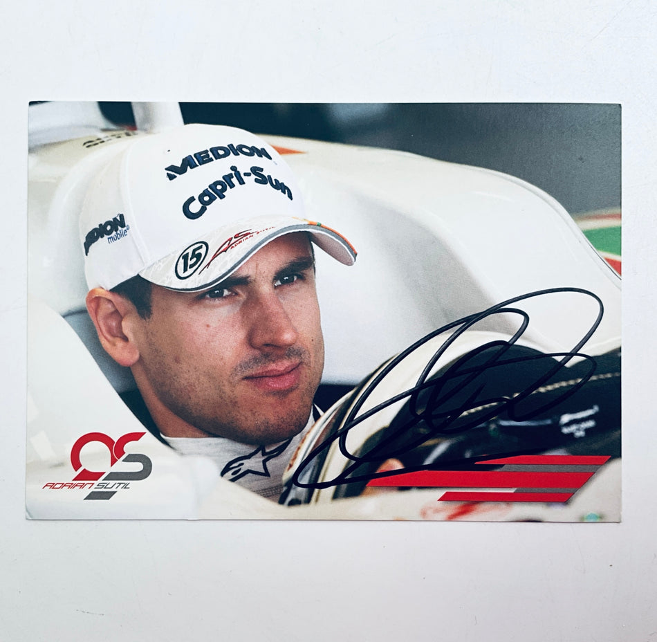 Signed Adrian Sutil driver card with blue autograph over white racing suit photo