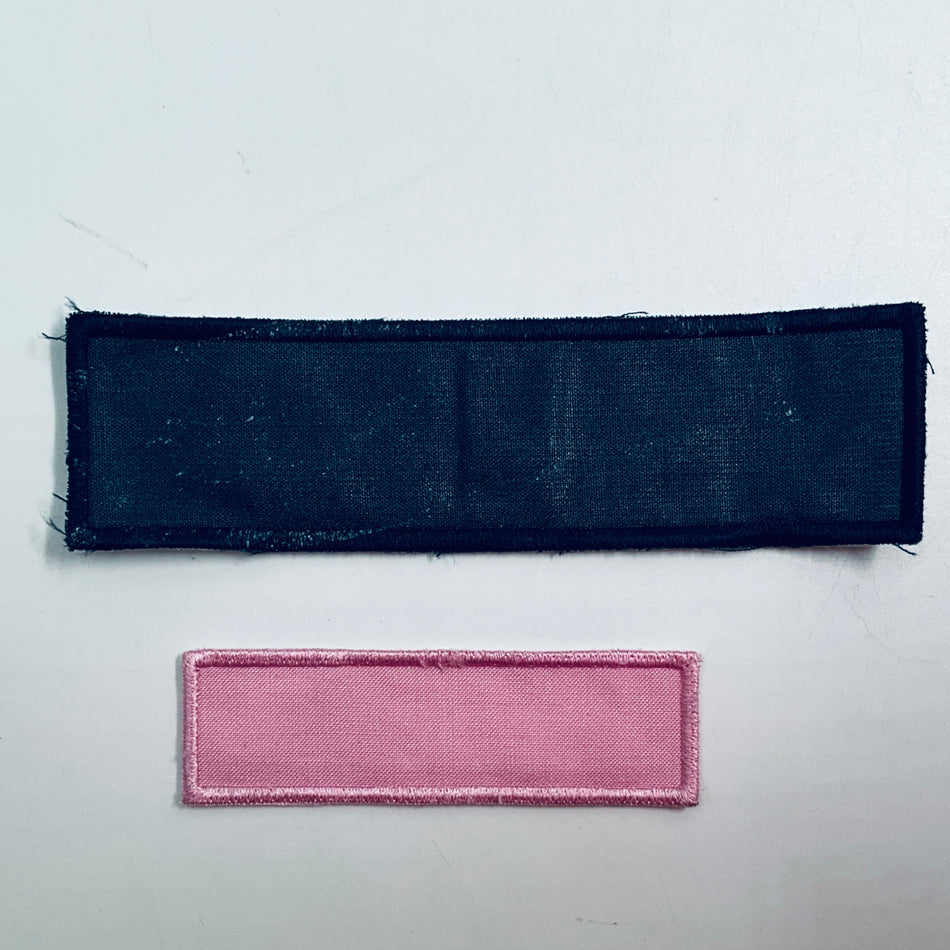 Two rectangular fabric patches: dark navy and pink with stitched border