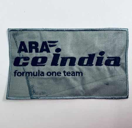Rectangular gray fabric patch with dark blue 'Formula One team' logo text