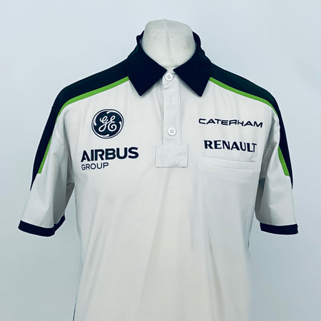 Team polo shirt with white front, navy collar, green piping, and chest brand logos