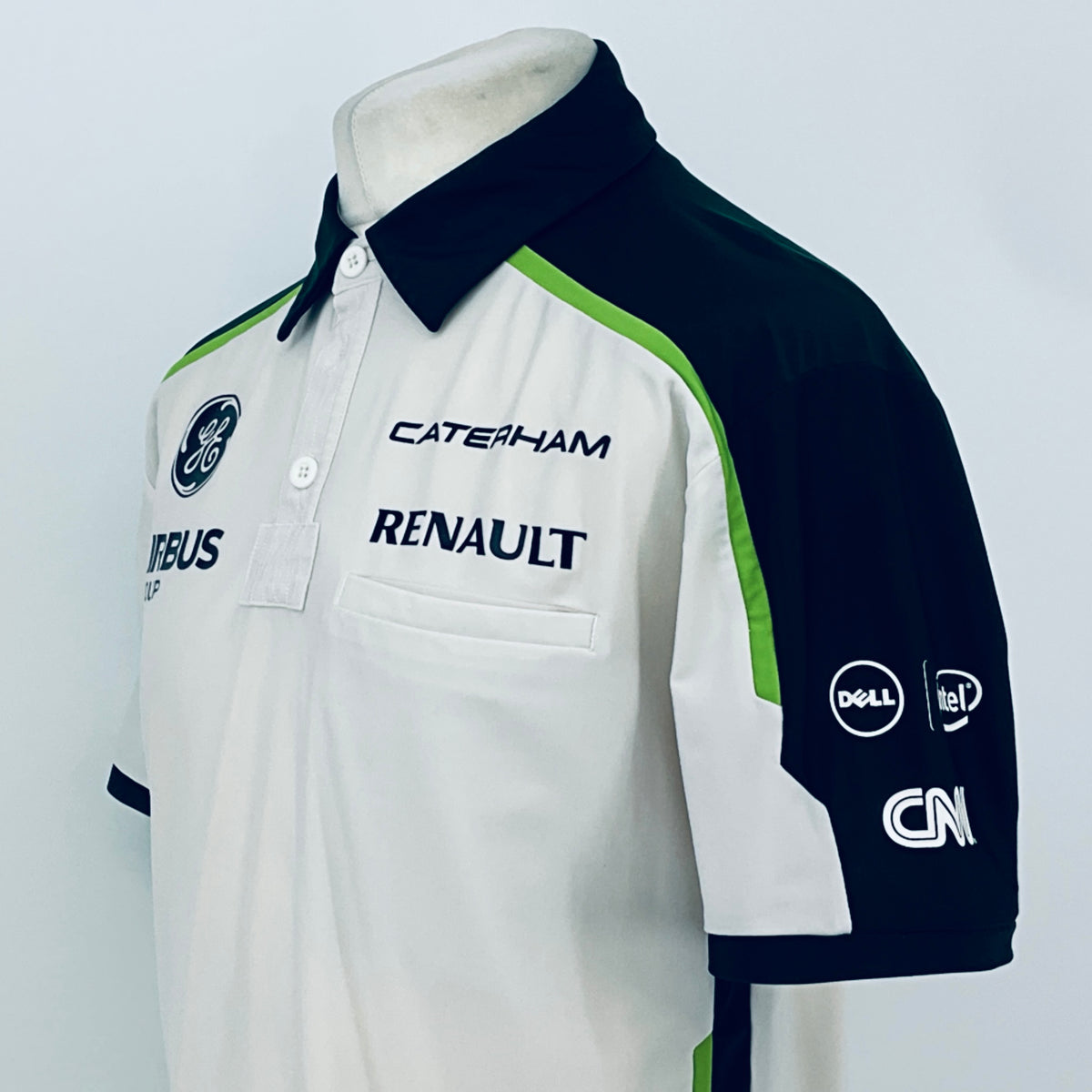 Team polo shirt side view: white front with navy sleeve and green stripe detailing