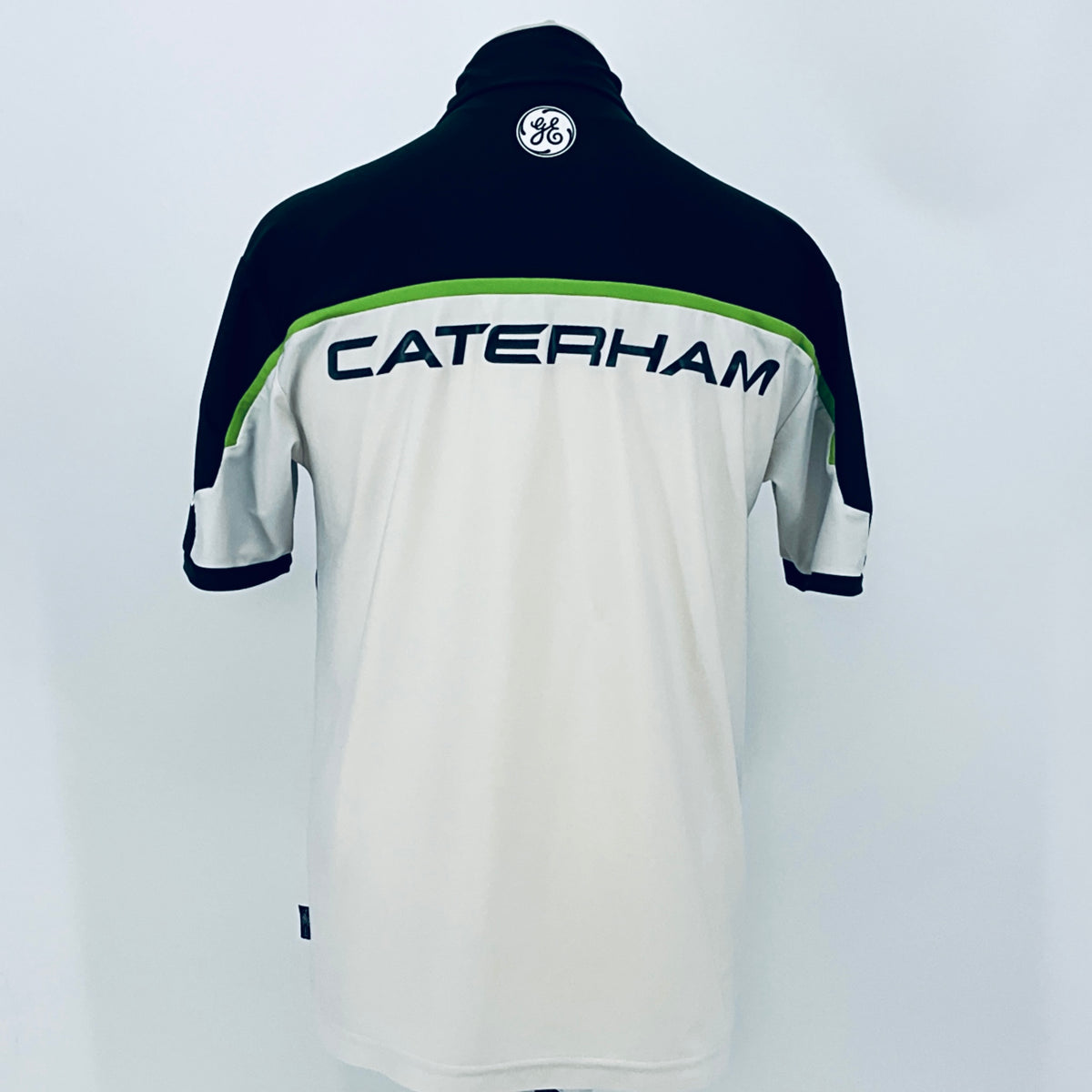 Team polo shirt back view with dark navy top and white lower section, green trim