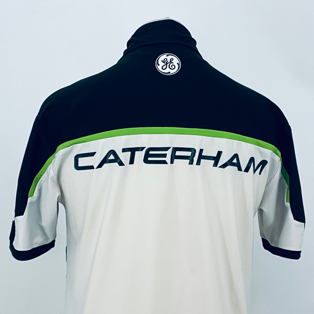 Team polo shirt back close-up: dark navy collar area with CATERHAM branding