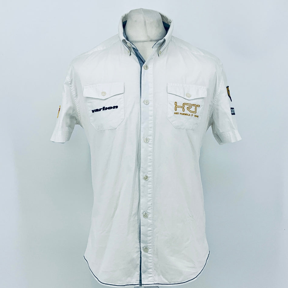 White pit crew button-up shirt with short sleeves, front buttons, and team chest patches.
