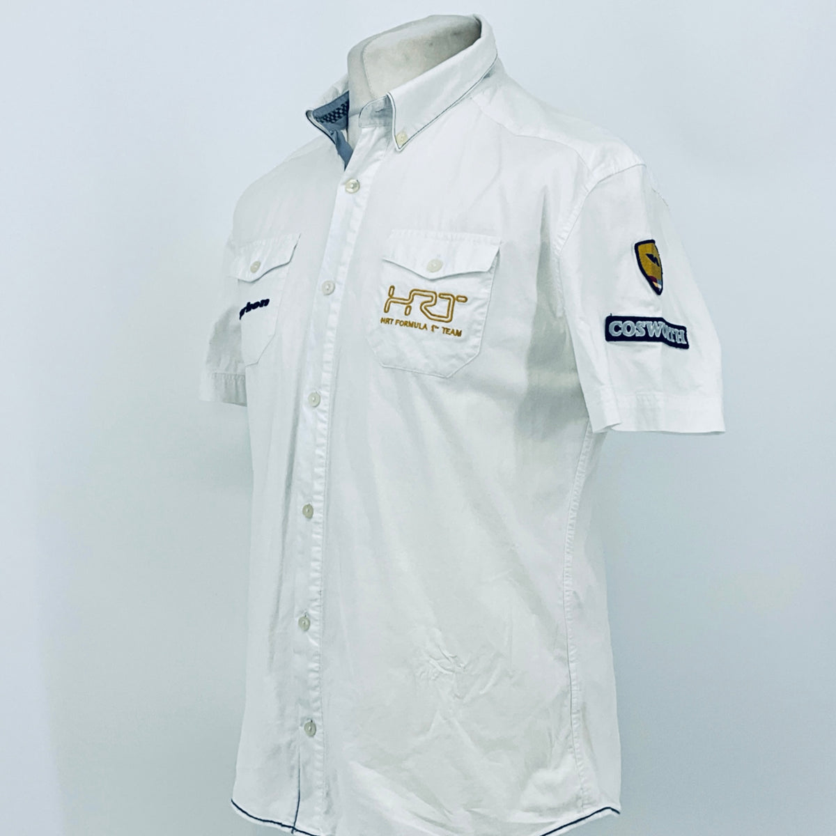 White pit crew button-up shirt with short sleeves and side chest logo patch detail.