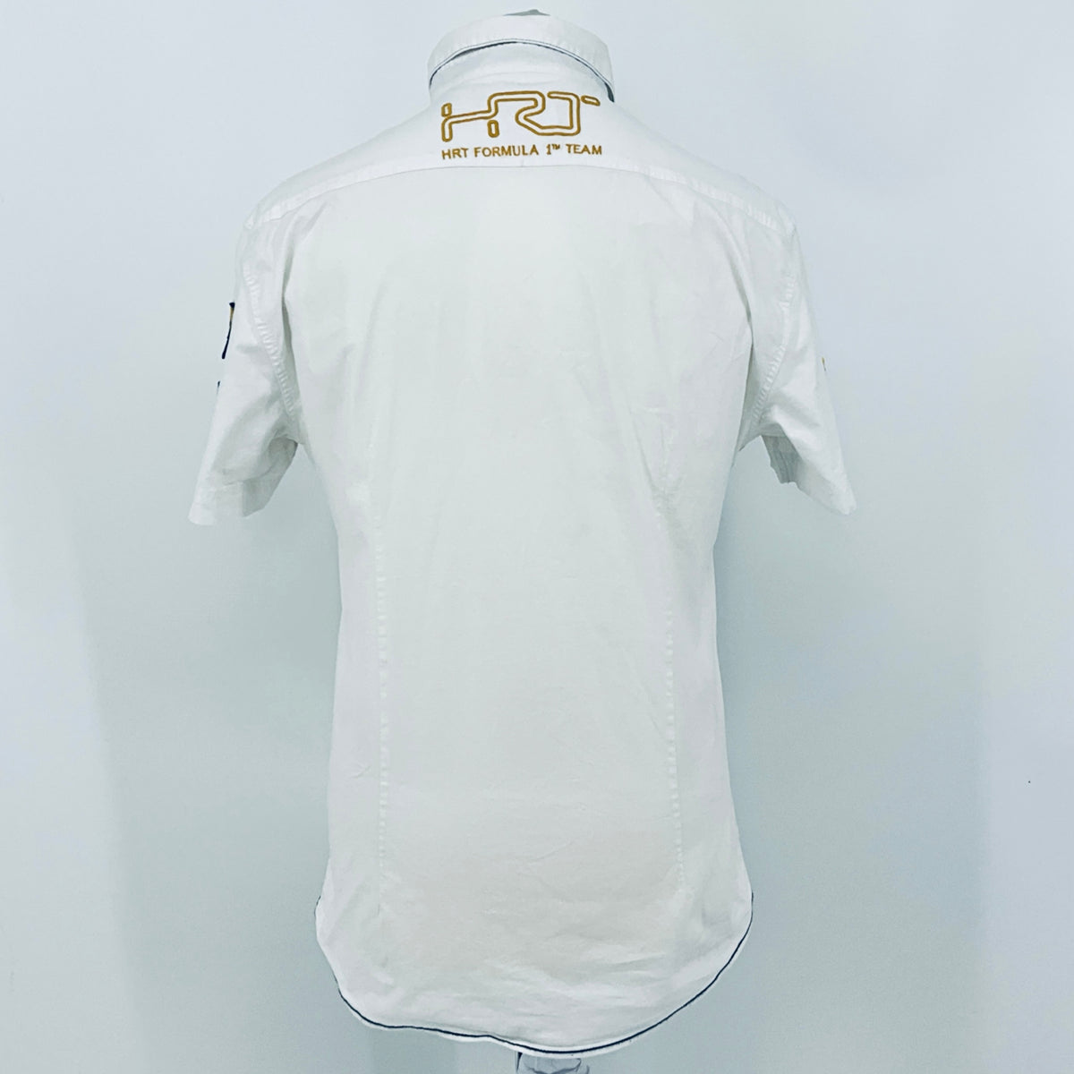 White pit crew shirt back view with embroidered shoulder logo and buttoned collar.