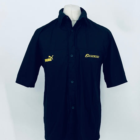 Dark navy short-sleeve button-up shirt with collar; PUMA and JORDAN logos on chest.