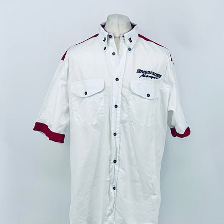 White button-up F1 employee shirt with maroon sleeve cuffs, chest pockets, and logos.