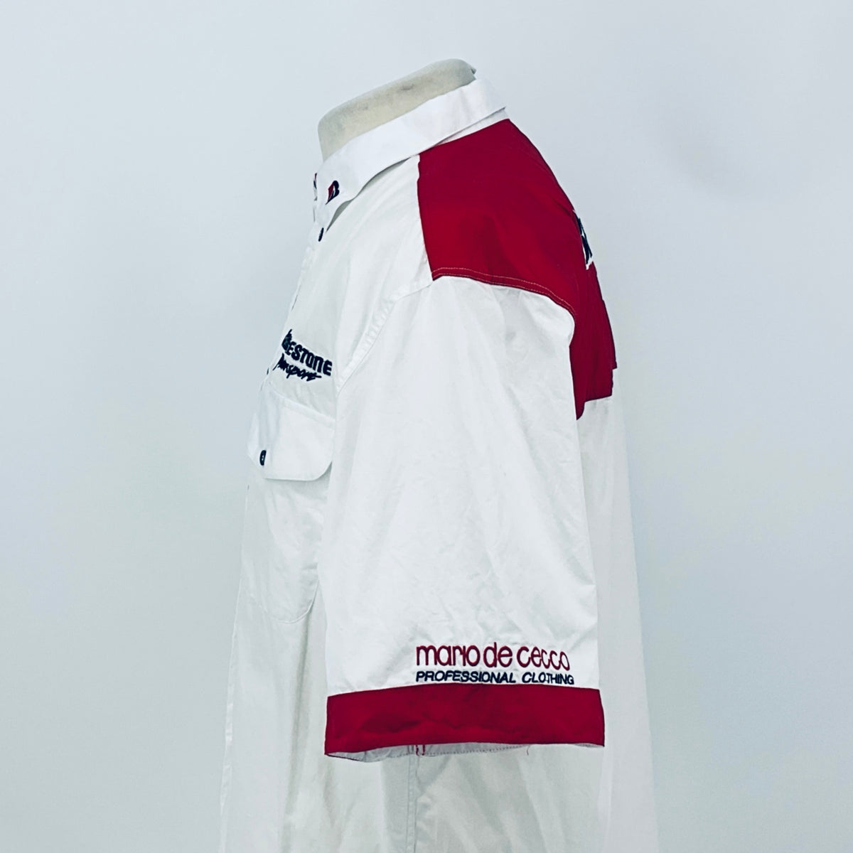 White shirt with maroon shoulder panel and maroon hem band, short sleeves with logo.