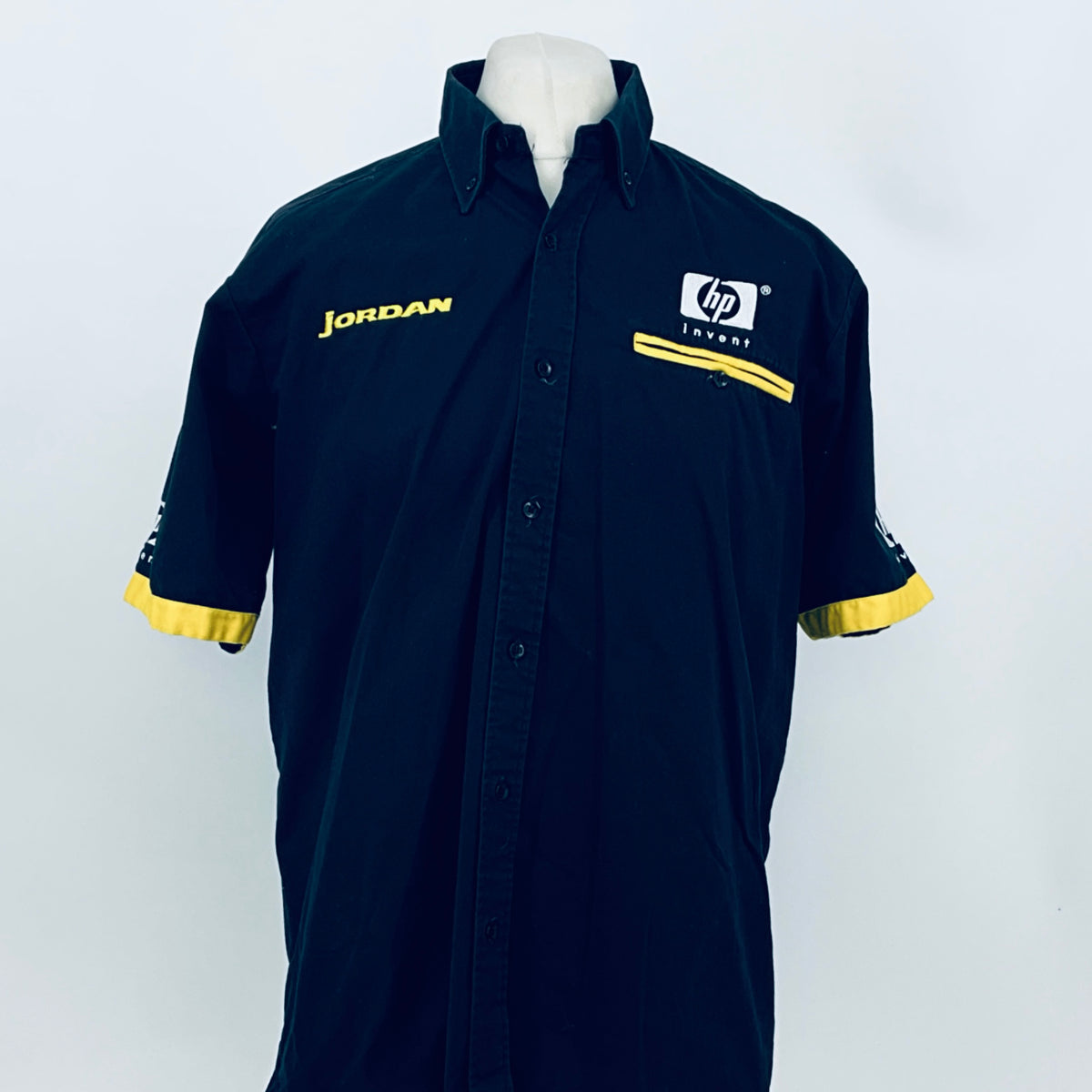 Dark blue button-up team shirt with yellow armband trim, JORDAN and hp invent logos