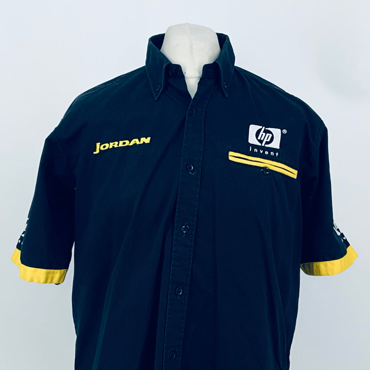 Dark blue team shirt front, yellow cuff stripe, JORDAN logo and hp invent chest badge