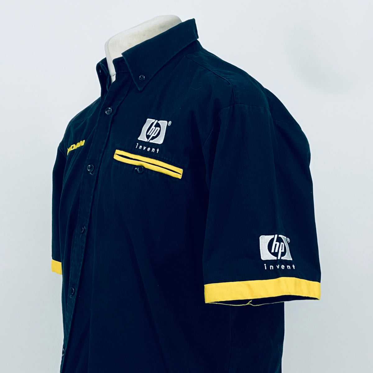 Dark blue shirt with yellow cuff stripe and hp invent chest logo, side view