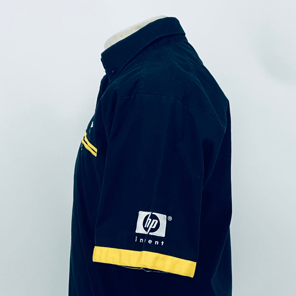 Dark blue team shirt with yellow chest stripe and hp invent logo, side/back close
