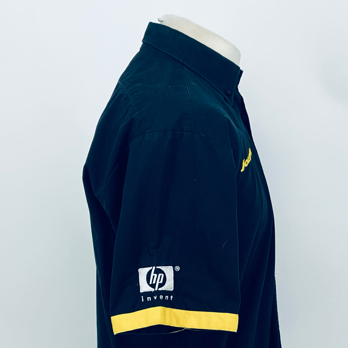 Dark blue team shirt side view with JORDAN sleeve detail and yellow chest stripe