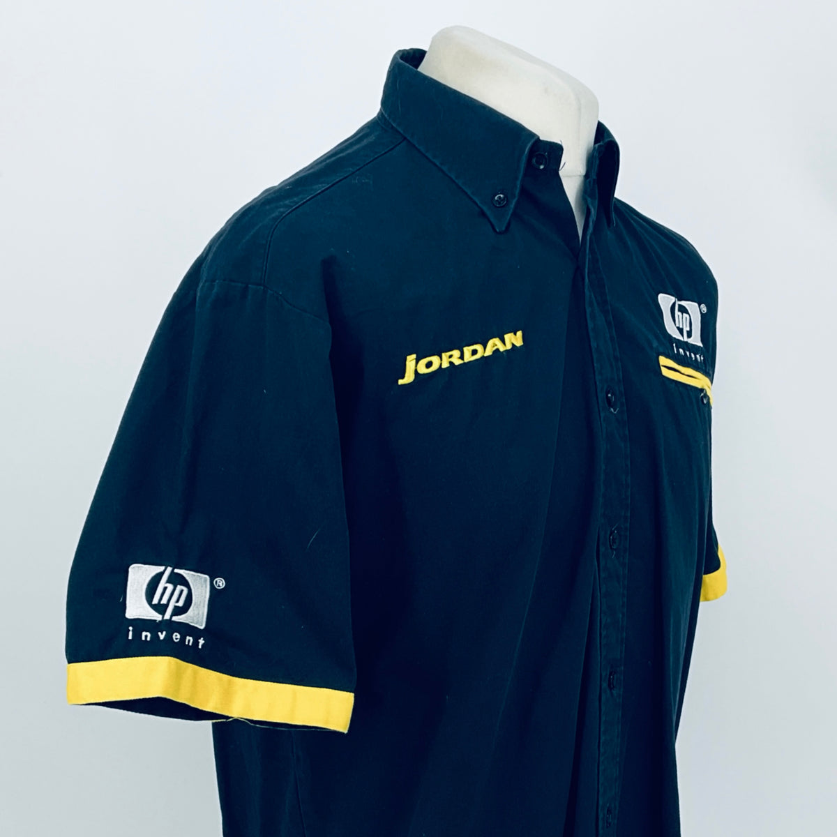 Dark blue team shirt with JORDAN front and hp invent sleeve logo, angled view