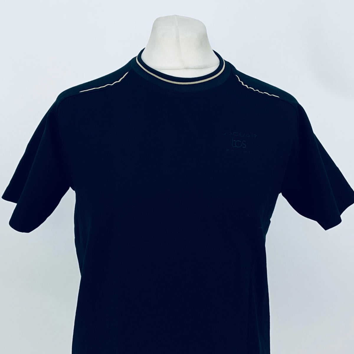 Dark navy crew-neck team T-shirt with contrast collar trim and small chest graphic