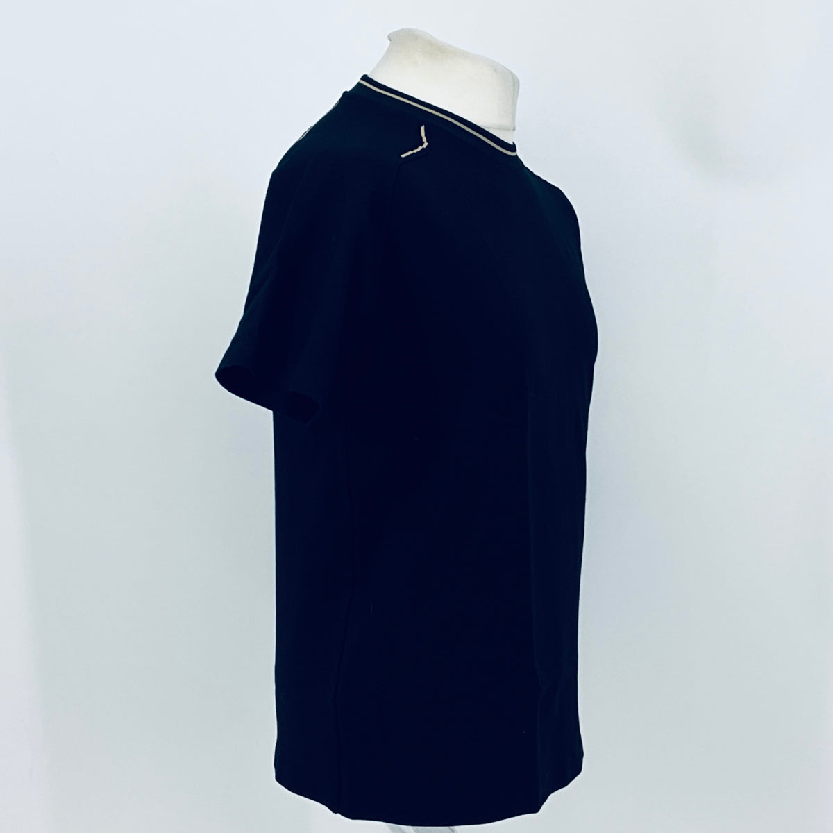 Dark navy crew-neck team T-shirt with contrast collar trim, side view