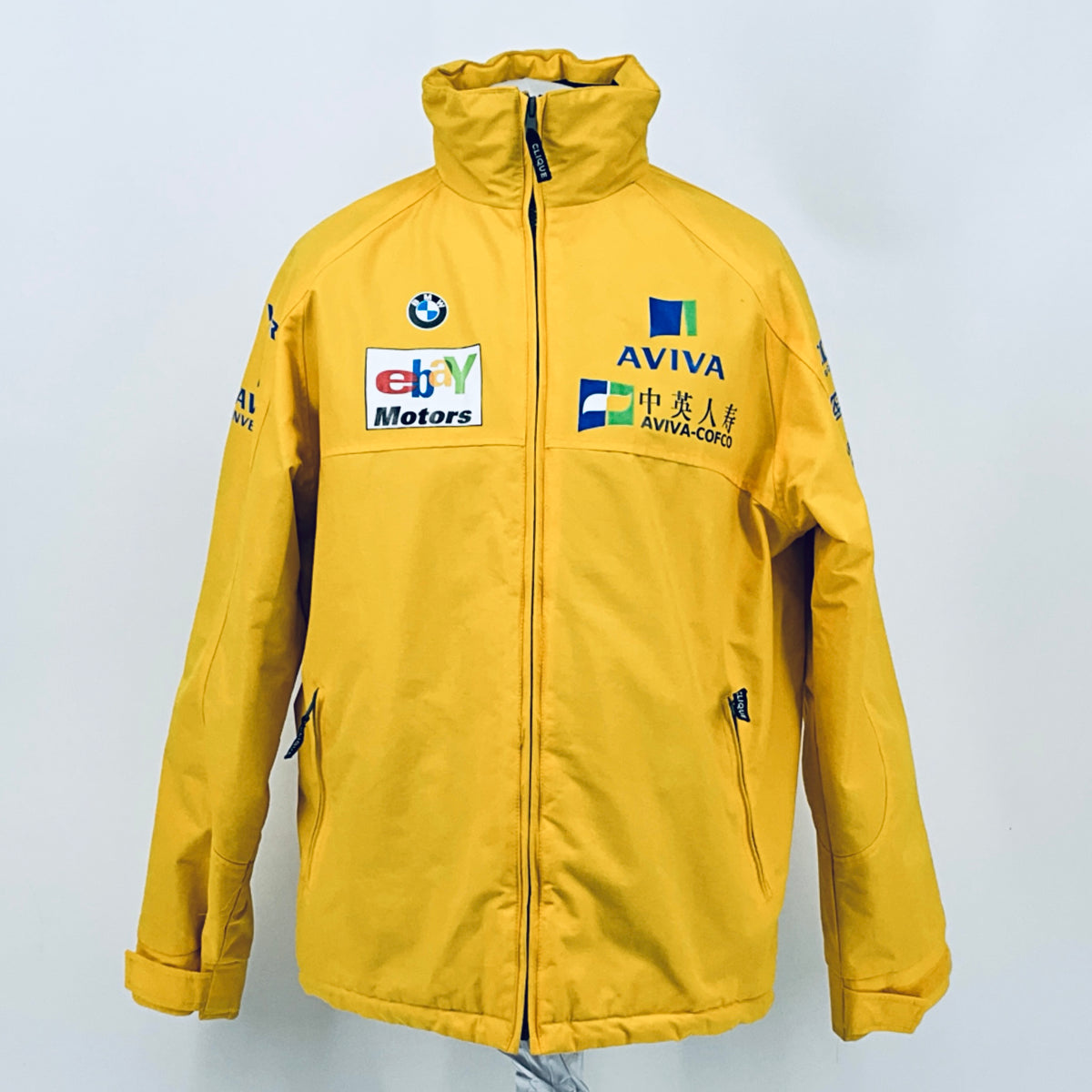 Yellow zip-up racing jacket with stand collar and front Aviva and eBay Motors patches.