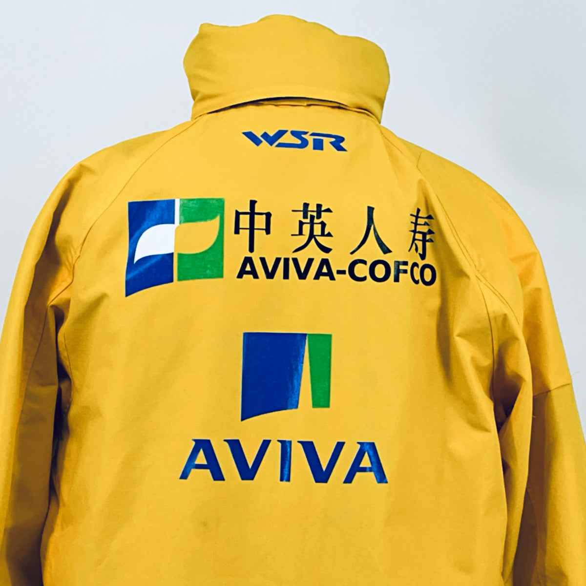 Yellow racing jacket close-up of back logos: WSR, AVIVA-COFCO, and AVIVA branding.
