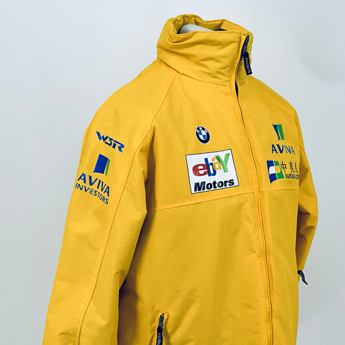 Yellow hooded racing jacket front view with zipper and Aviva, BMW, and eBay Motors logos.