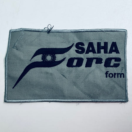 Rectangular embroidered patch with gray fabric and navy SAHA ORCA logo and text.