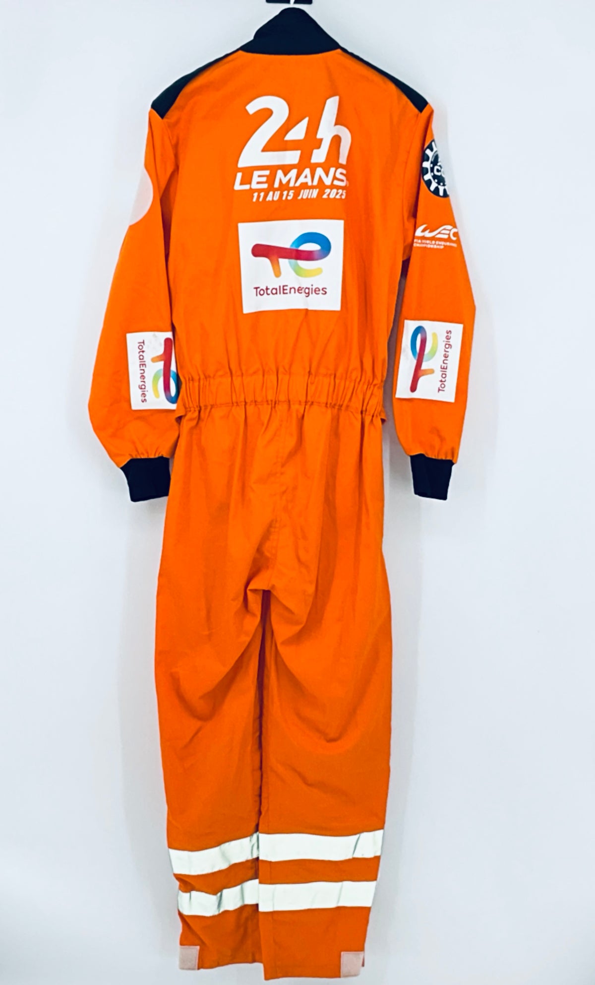 Orange back overalls with 24h Le Mans logo, TotalEnergies, and reflective stripe legs