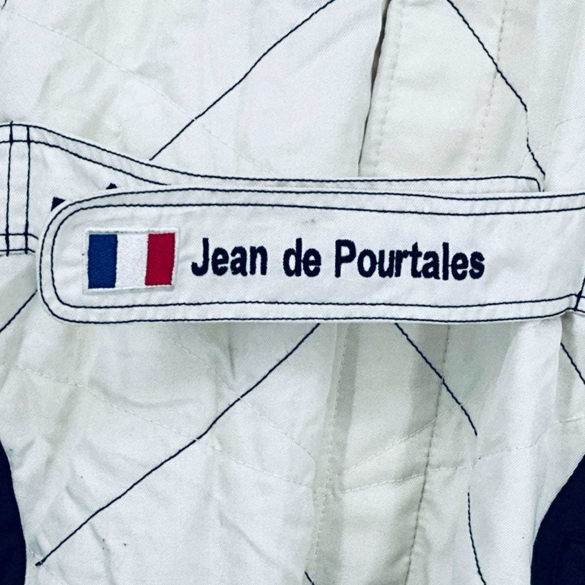 White race suit sleeve with Jean de Pourtalès name patch