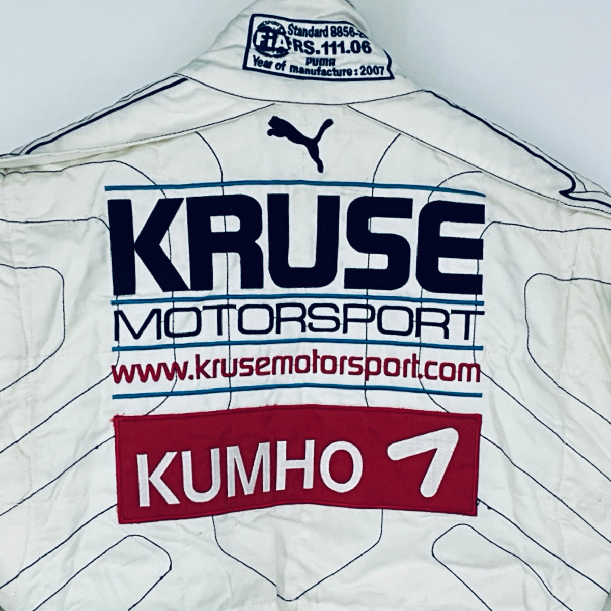 White race driver suit front panel with Kruse Motorsport, Kumho and Puma logos