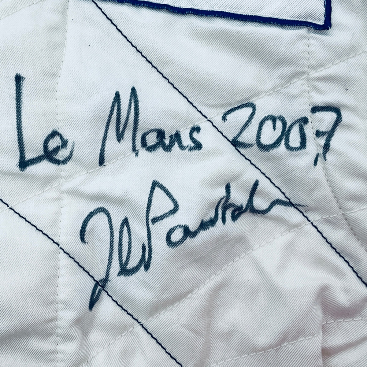 White suit panel with handwritten signature, 'Le Mans' and '2007'