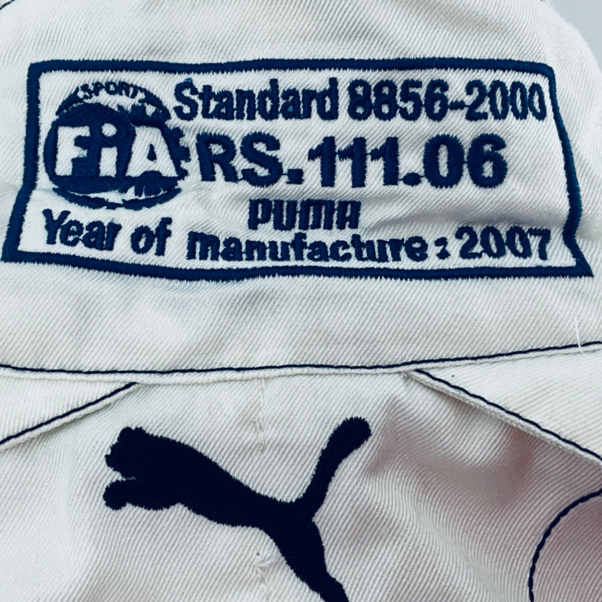 White suit collar label: FIA, Standard 8856-2000, year 2007, Puma mark