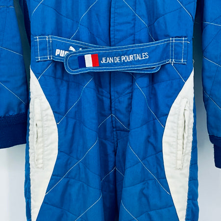Blue and white racing driver suit with Jean de Pourtalès name patch
