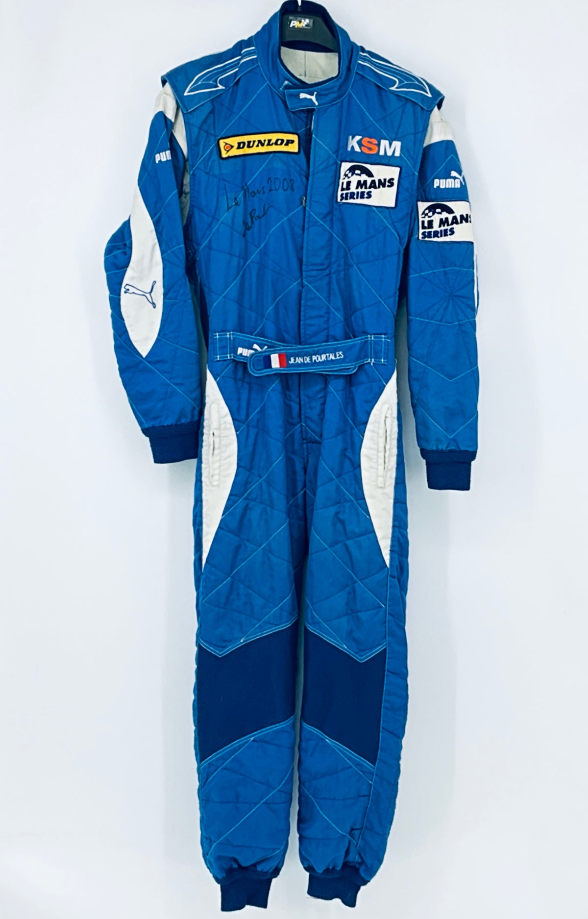 Blue full race driver suit with sponsor patches, white side panels, and logo details