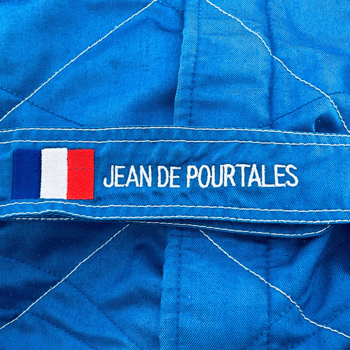 Blue racing suit sleeve with French flag and Jean de Pourtales name patch
