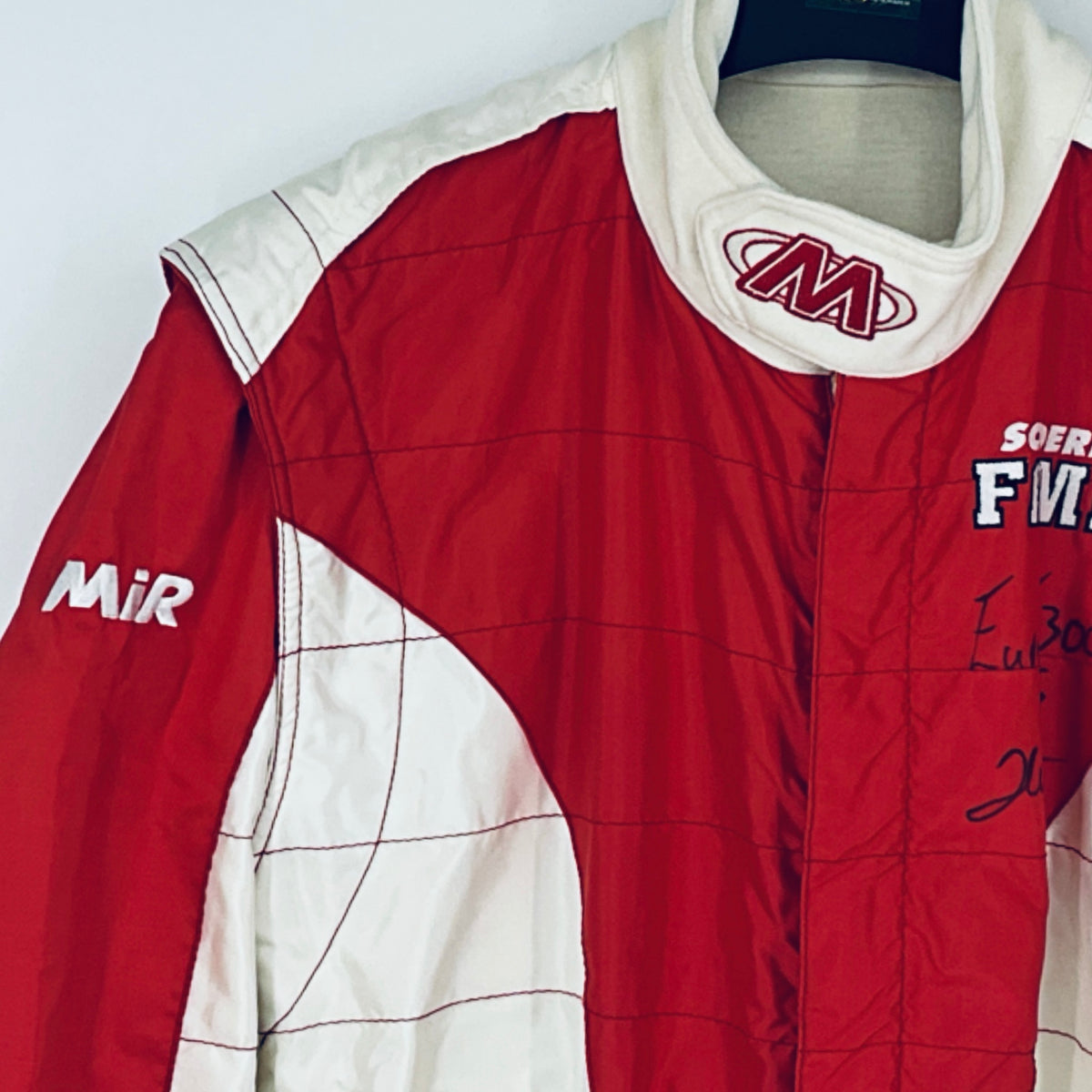 Red and white driver suit with embroidered collar logo and side sponsor mark