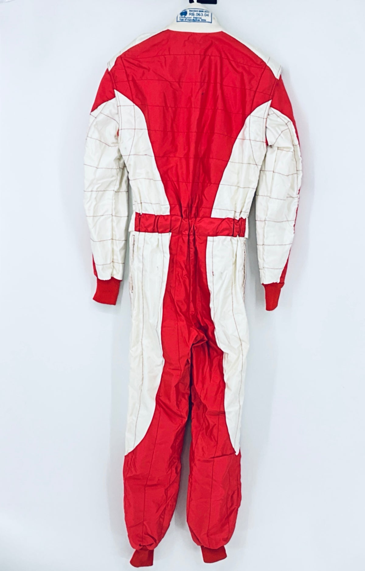 Back view of red and white racing driver suit with centered seam and cuffs