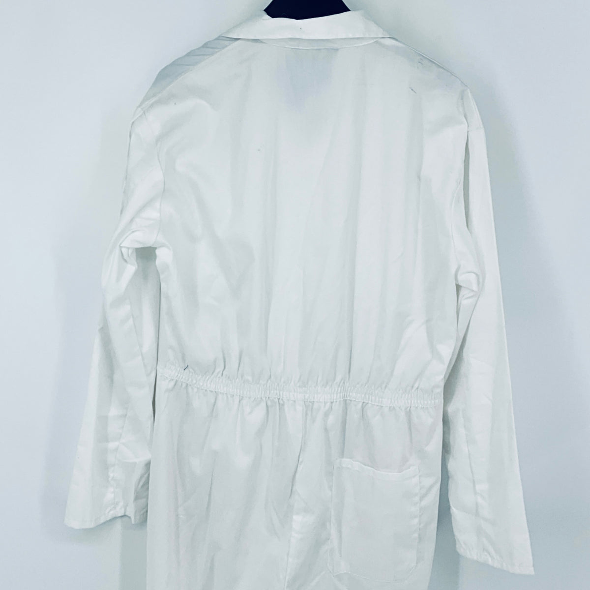 White overalls back view with elastic waistband and rear pocket