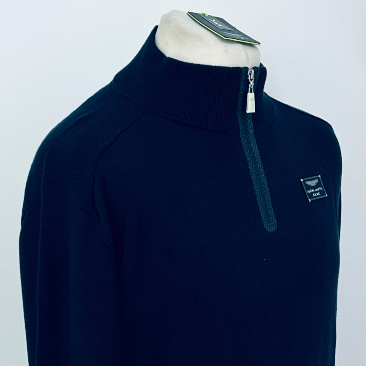 Navy quarter-zip jumper with ribbed collar and chest logo patch