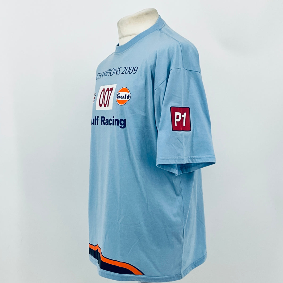 Light blue T-shirt side view with Champions 2009 graphic and red P1 patch
