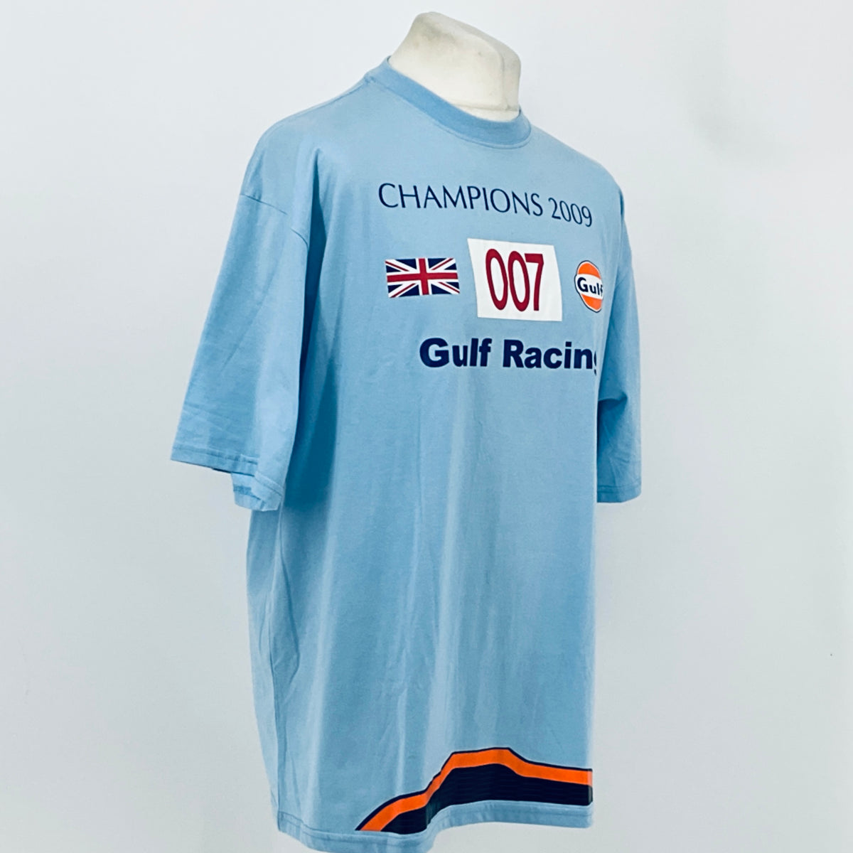 Light blue T-shirt front with Champions 2009 graphic and orange-dark blue hem stripe