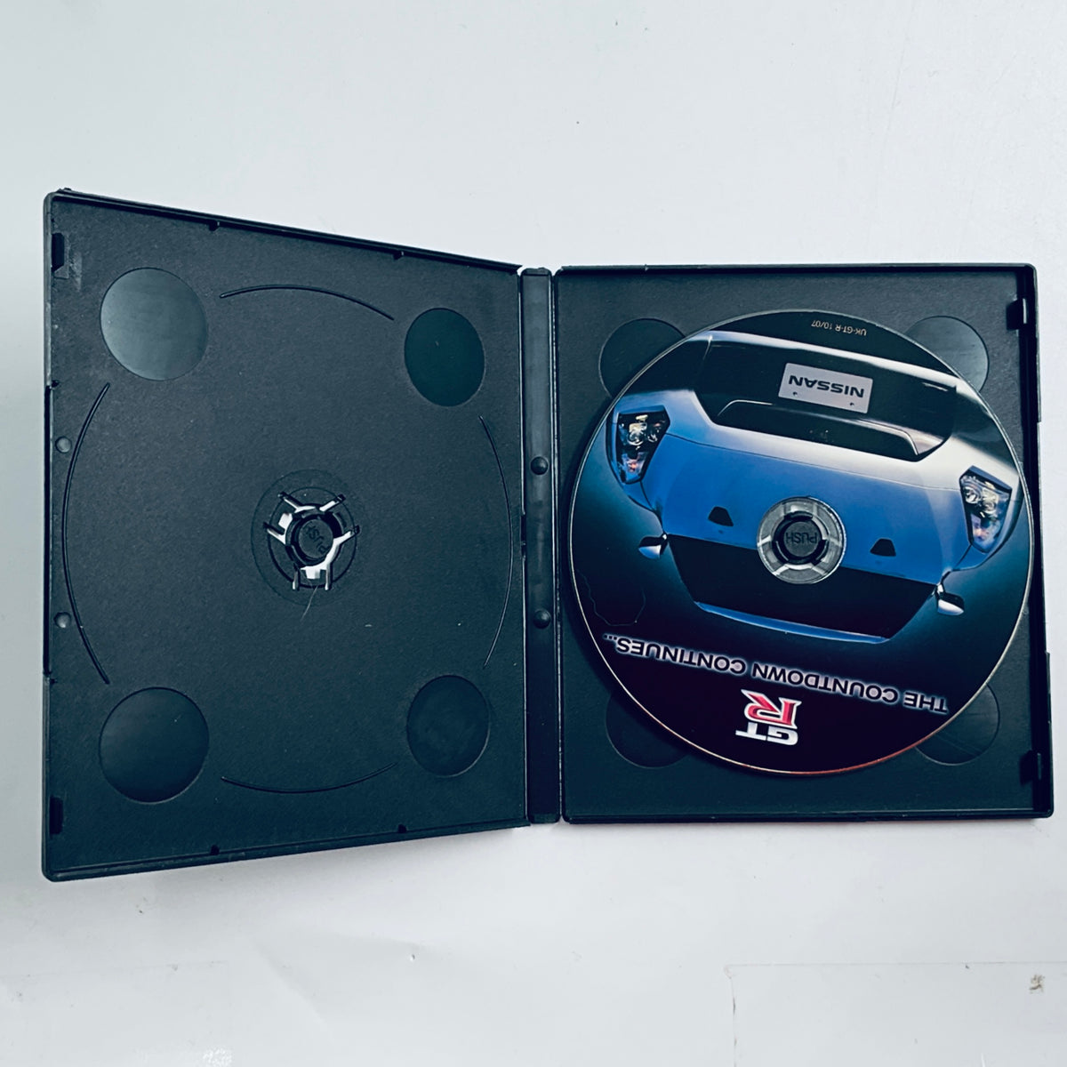 Opened disc case with Nissan GT-R logo and car graphic inserts