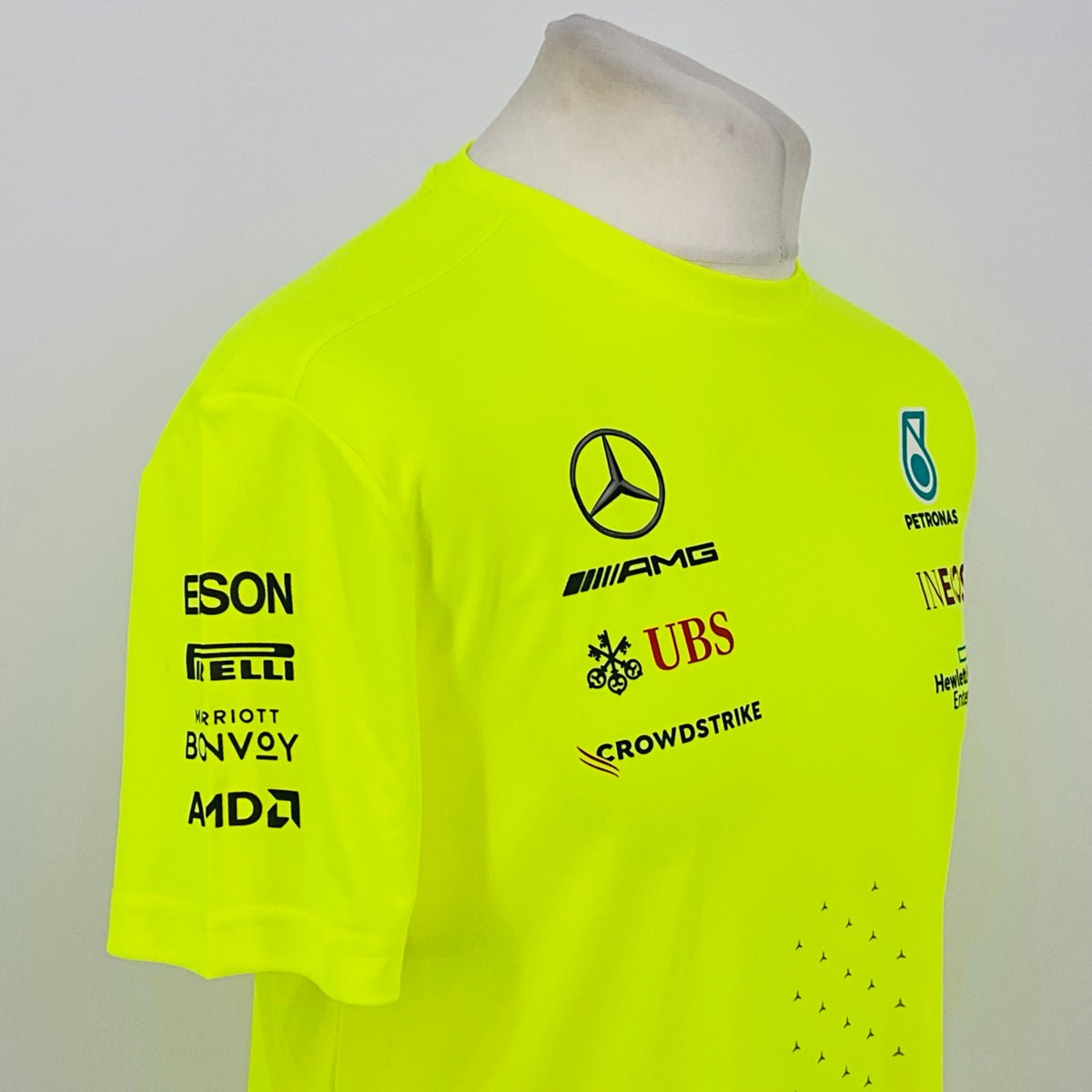 Neon yellow hi-vis T-shirt front side view with Mercedes and Petronas logos and dotted detail