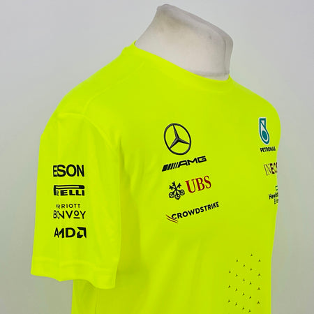 Neon yellow hi-vis T-shirt front side view with Mercedes and Petronas logos and dotted detail