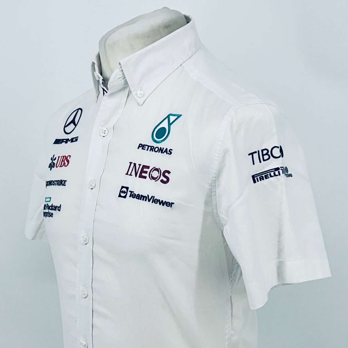 White team shirt with Petronas Ineos, TeamViewer, and TIBCO Pirelli sleeve logos
